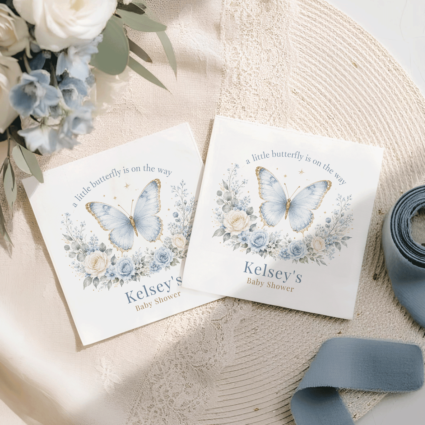 Two white cards with blue butterflies, flowers, and "Kelsey's Baby Shower" text.
