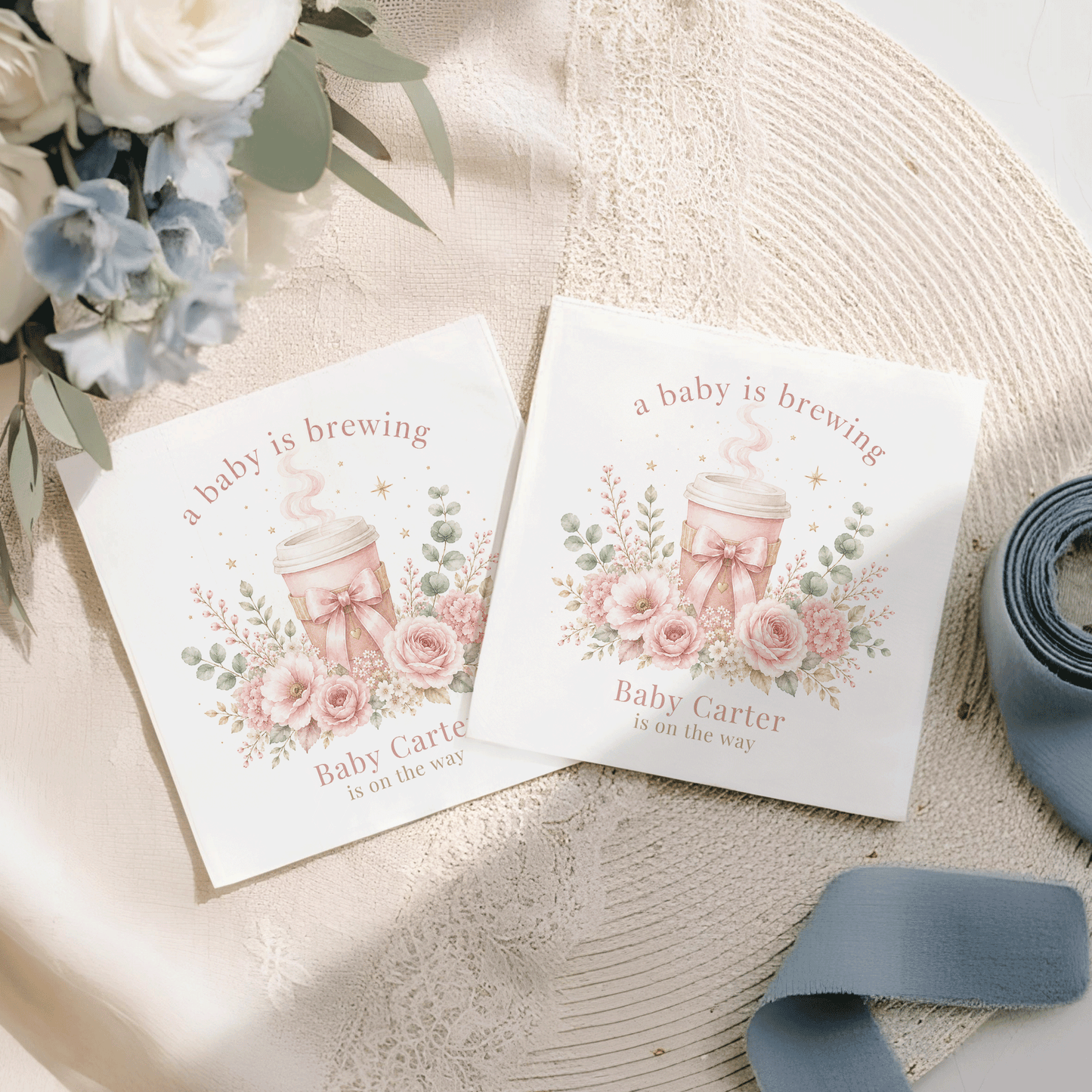 Two square cards with "a baby is brewing" and floral design.
