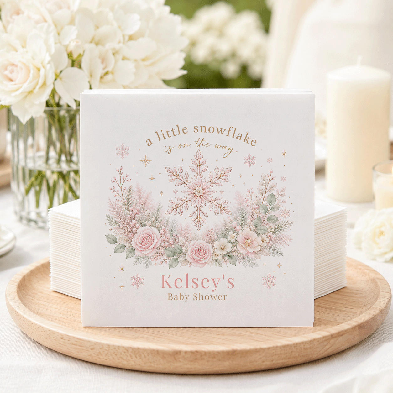 "A little snowflake is on the way" and "Kelsey's Baby Shower" on a decorative napkin.
