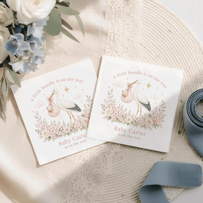 Two baby shower cards with stork design and text "a little bundle is on the way".