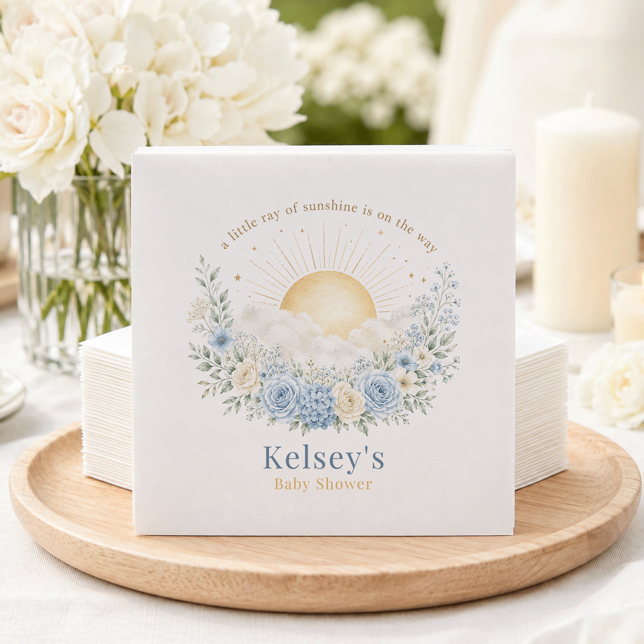 "Kelsey's Baby Shower" napkins with sun and floral design.
