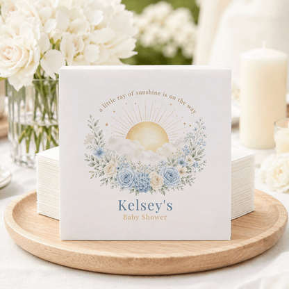 "Kelsey's Baby Shower" napkins with sun and floral design.