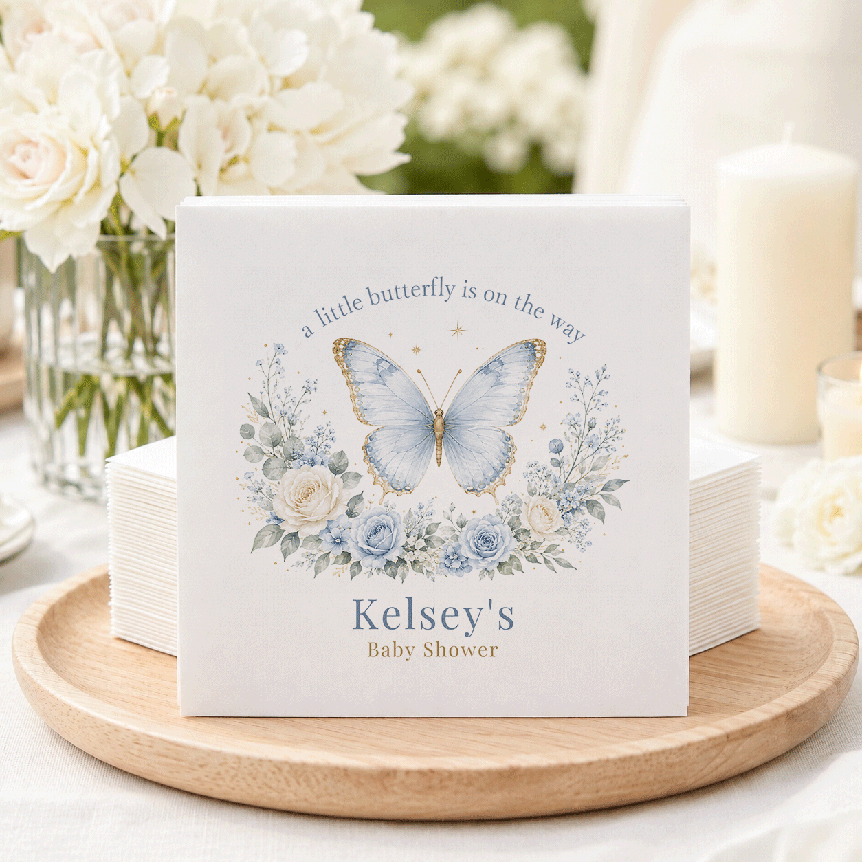 Kelsey's Baby Shower napkins feature a blue butterfly and floral design.