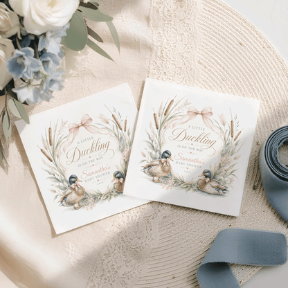 Two baby shower invitations with a duckling theme and floral accents.