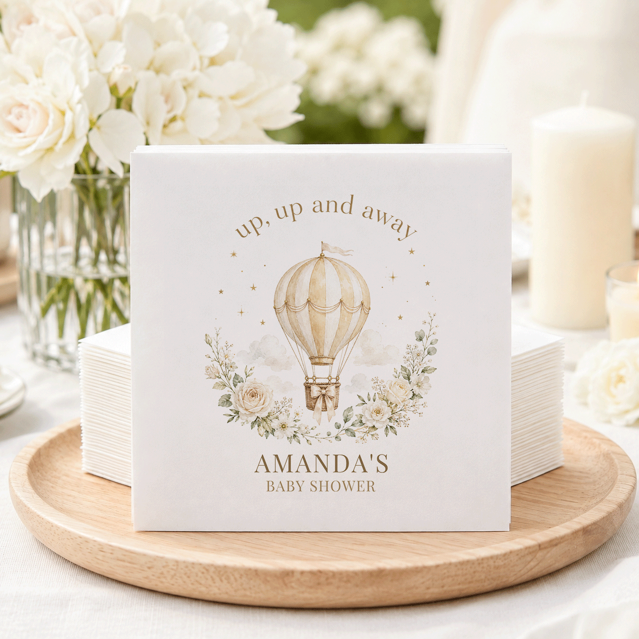 White cocktail napkins with hot air balloon, "up, up and away," and "Amanda's Baby Shower."