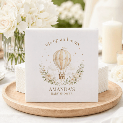 White cocktail napkins with hot air balloon, "up, up and away," and "Amanda's Baby Shower."