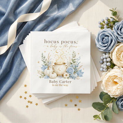 Dusty blue baby shower napkin with a gold moon cauldron, blue pumpkins, blue roses and a personalized baby name