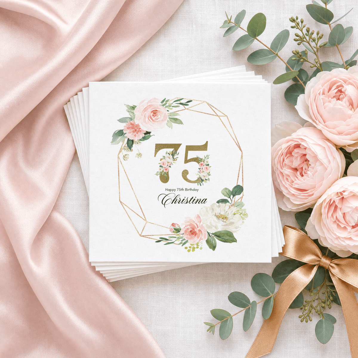 Personalized 75th birthday cocktail napkins with a gold floral 75, blush watercolor roses and custom name