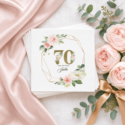 Elegant personalized 70th birthday cocktail napkins with gold-toned 70, blush watercolor roses and custom name