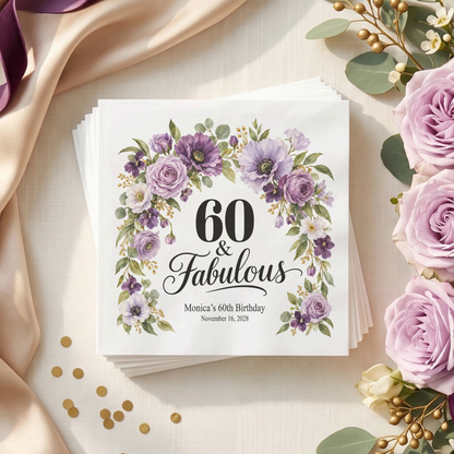 White napkin with “60 & Fabulous” in black, framed by a purple floral arch, with two personalized text lines below.