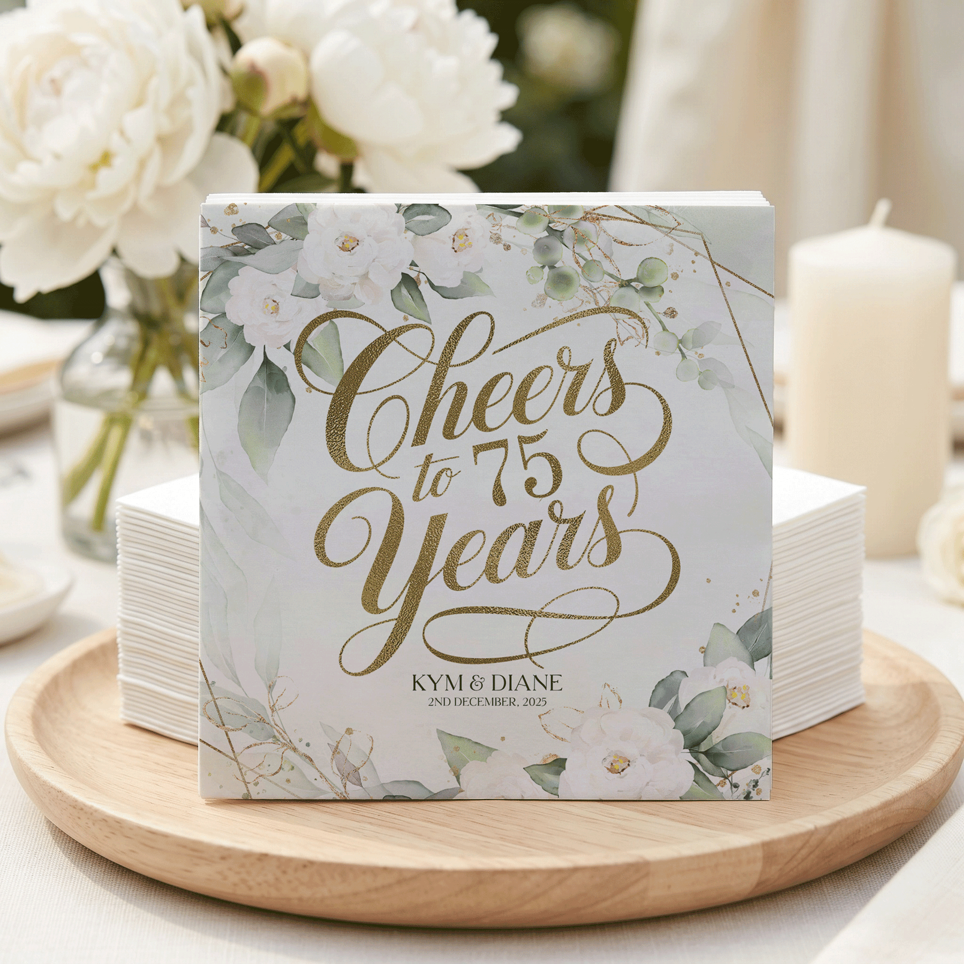 Cheers to 75 Years Kym & Diane on a card with floral and gold accents.