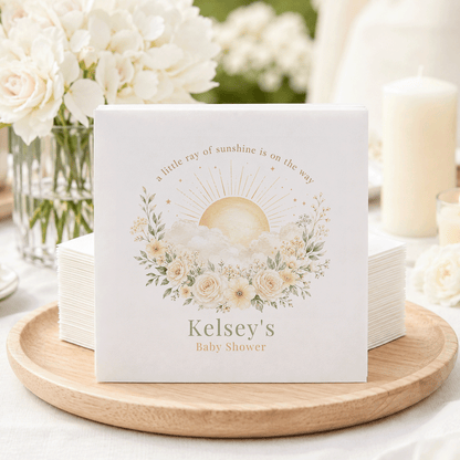 Napkins with sun, clouds, flowers, and text "Kelsey's Baby Shower".