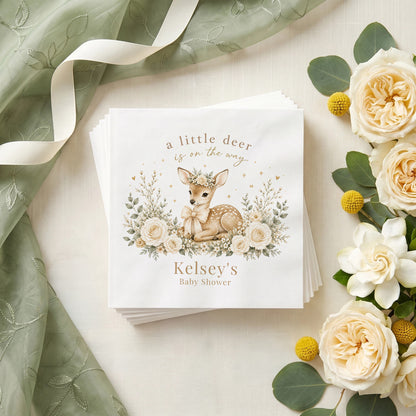 Cream and sage baby shower napkin with a fawn in a flower crown, ivory roses, wildflowers and a personalized name in warm taupe
