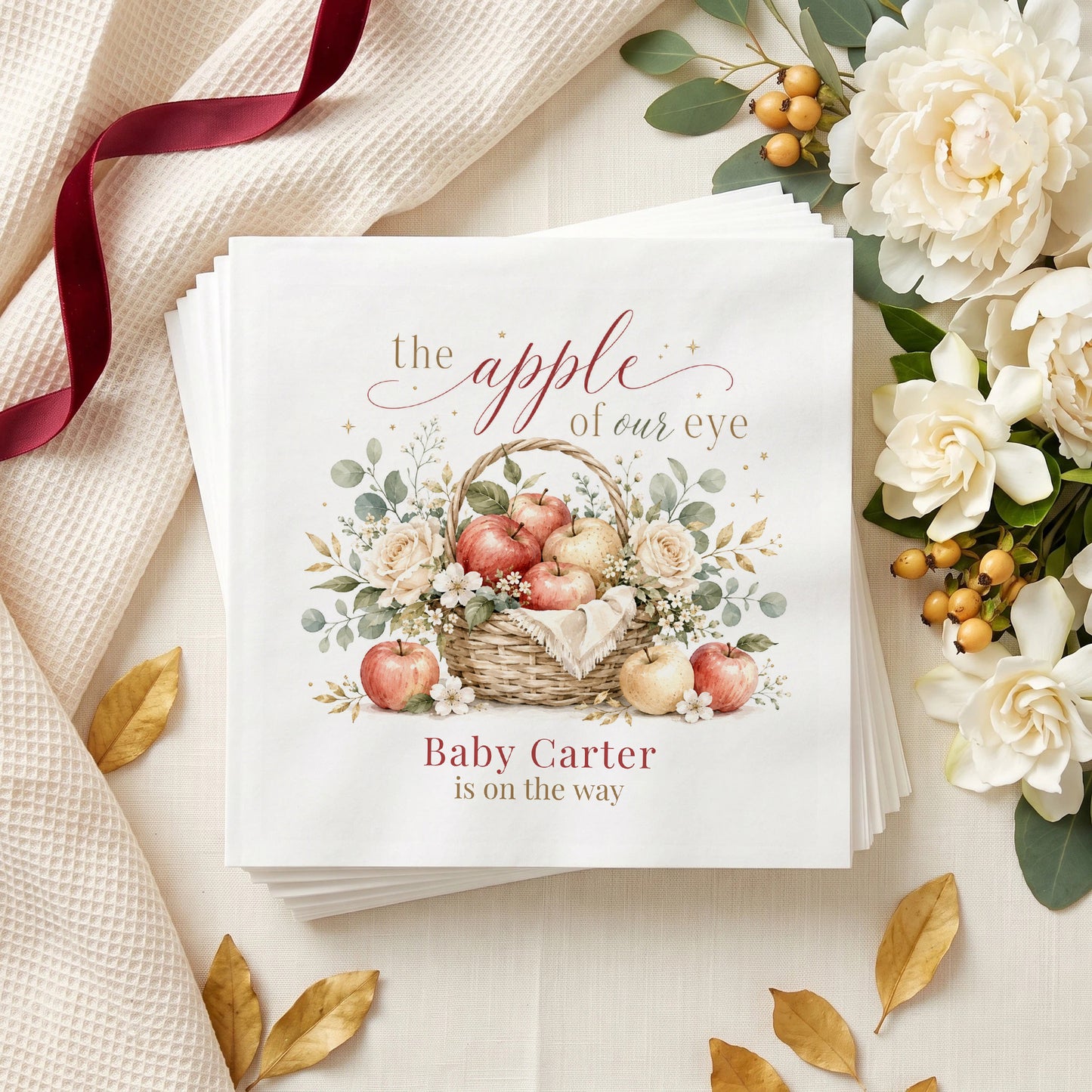 Cream and red baby shower napkin with an apple basket, ivory roses, white blossom and a personalized baby name