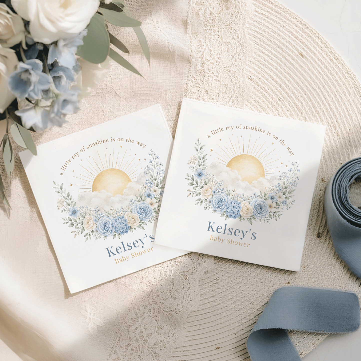 Two baby shower napkins, featuring "Kelsey's Baby Shower" and sun design.