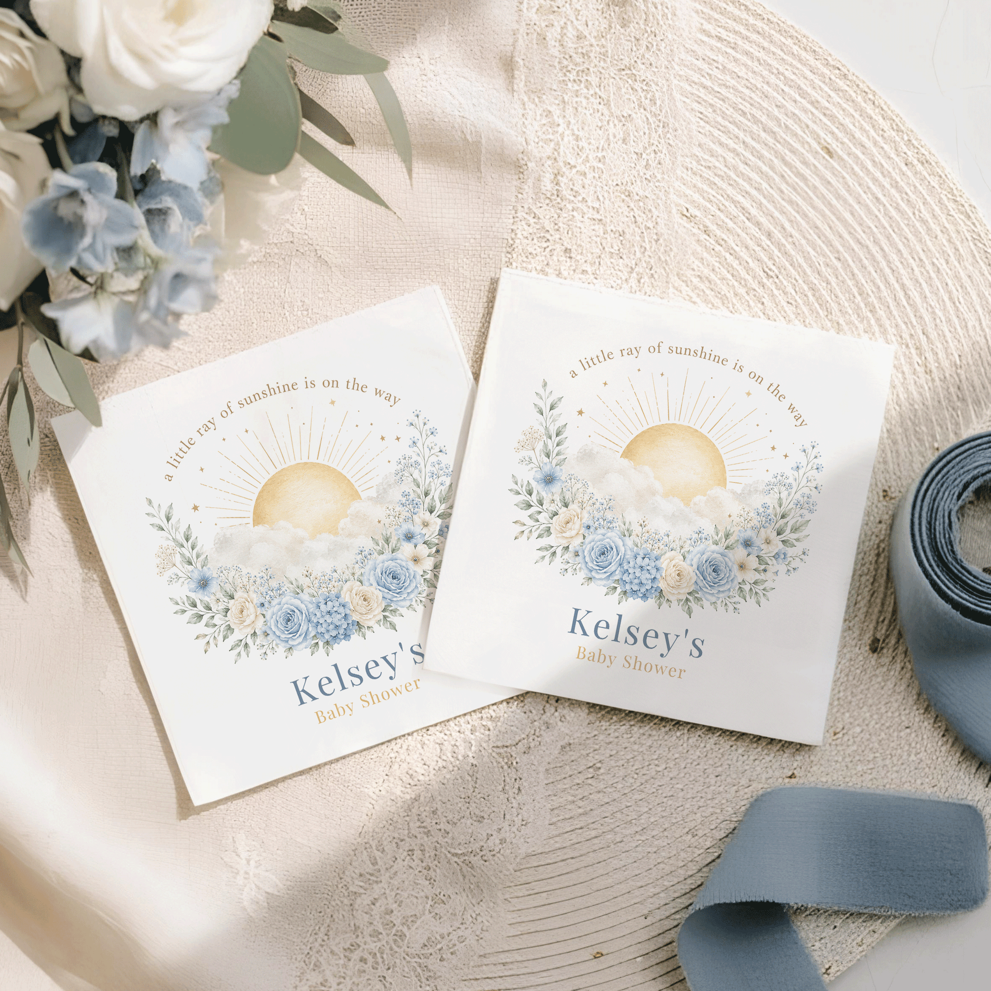 Two baby shower napkins, featuring "Kelsey's Baby Shower" and sun design.