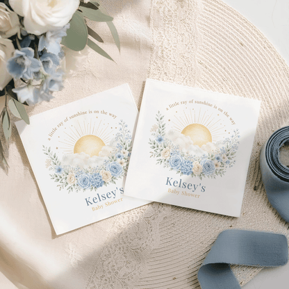 Two baby shower napkins, featuring "Kelsey's Baby Shower" and sun design.