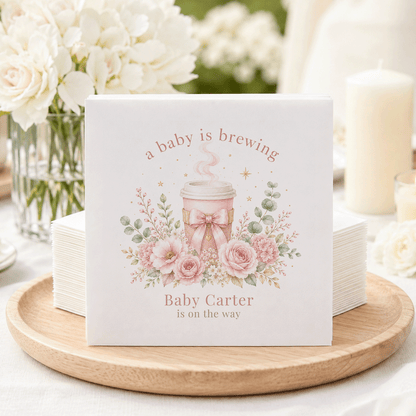 Baby shower napkins with "a baby is brewing" and "Baby Carter is on the way."