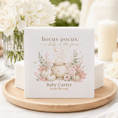 Napkins with "Hocus Pocus, A Baby is the Focus" and "Baby Carter is on the Way."
