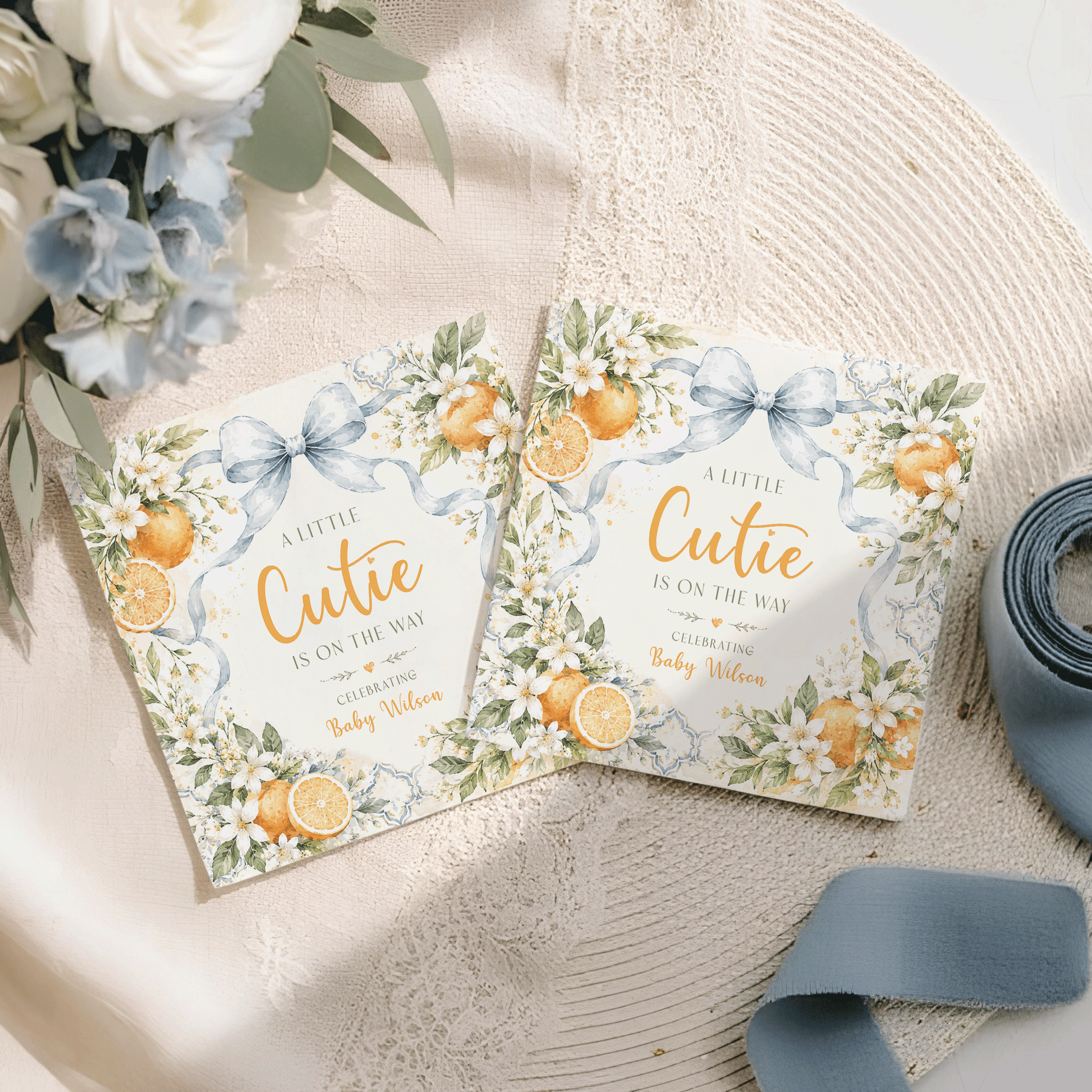 Baby shower invitations with "A Little Cutie is on the Way" and "Baby Wilson".