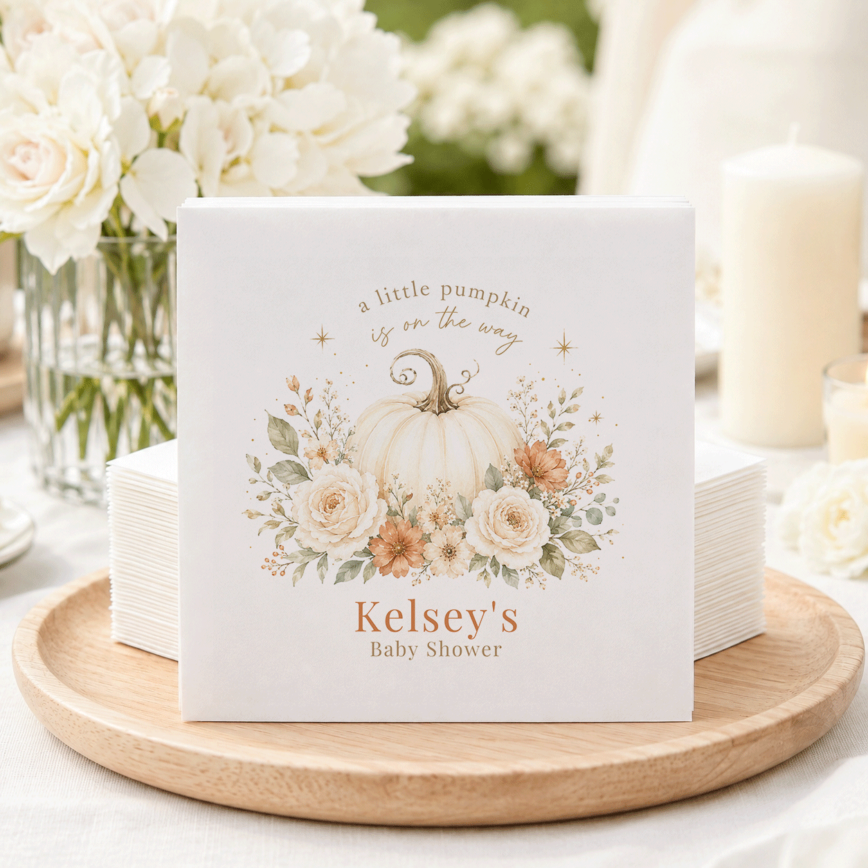 Baby shower napkins with pumpkin and floral design, text "Kelsey's Baby Shower".