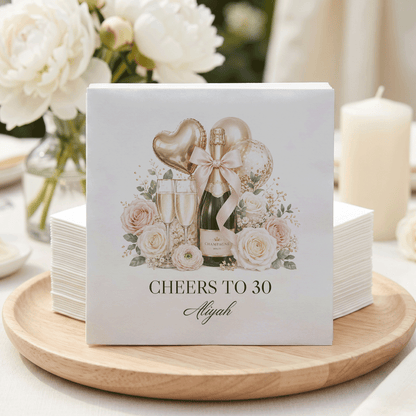 Napkins with "Cheers to 30 Aliyah" and champagne graphic.