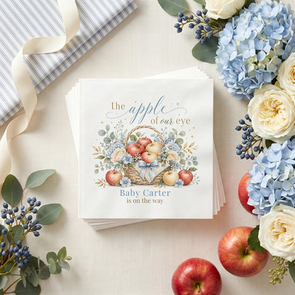 Dusty blue baby shower napkin with an apple basket, blue hydrangea, cream roses and a personalized baby name