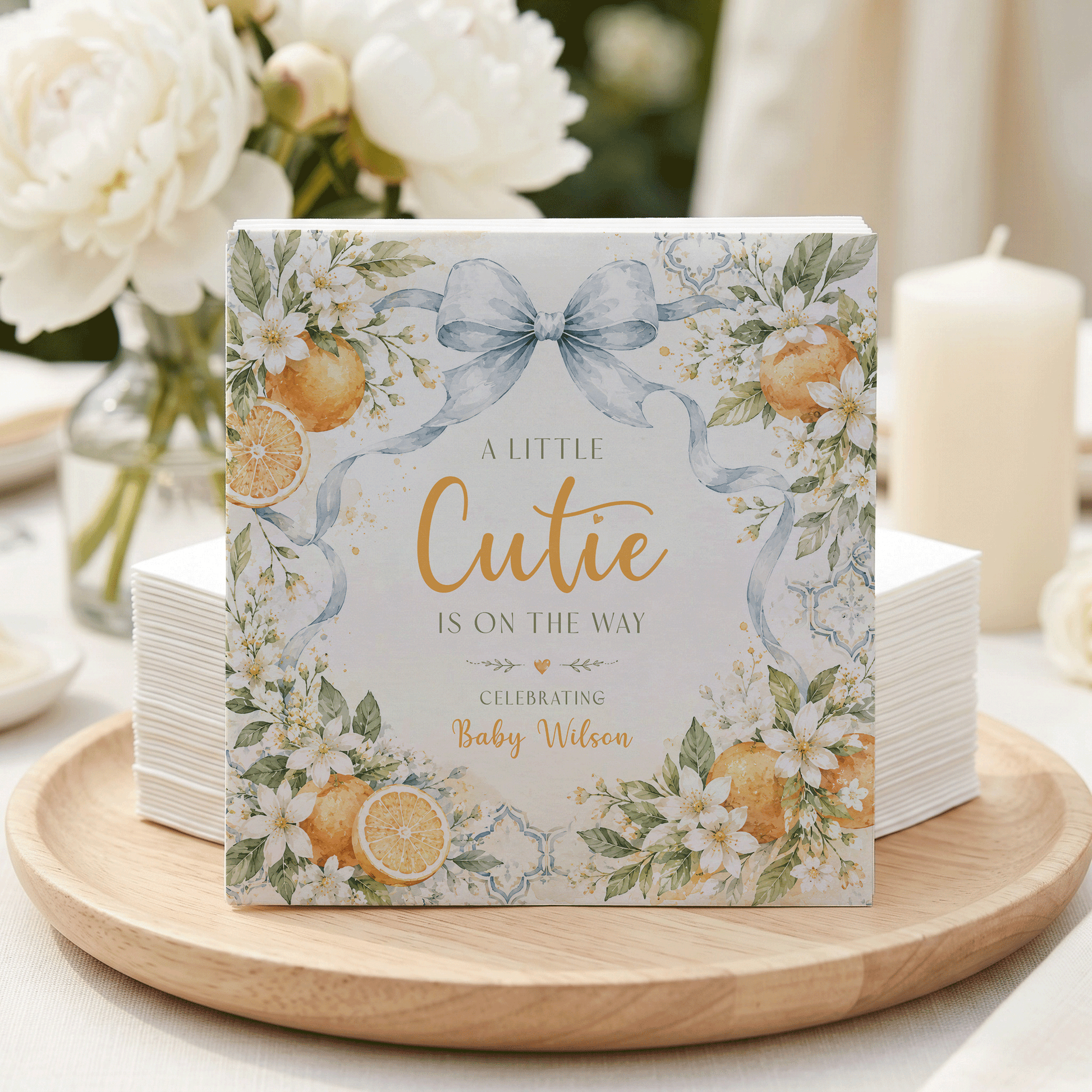 "A Little Cutie is on the Way" baby shower napkins with oranges and flowers.