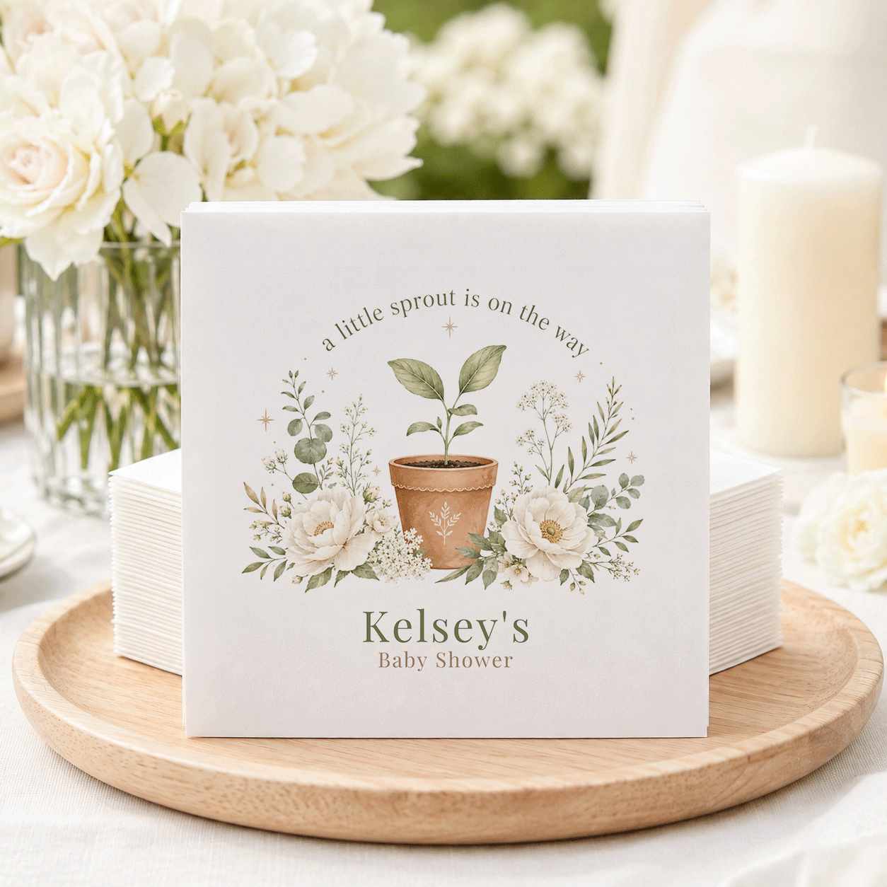 Baby shower napkins with a potted seedling and floral wreath, reading "Kelsey's Baby Shower."