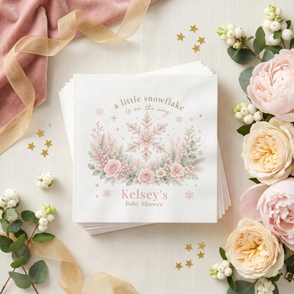 Blush pink baby shower napkin with a gold traced snowflake, pink roses, frosted berries and a personalized name