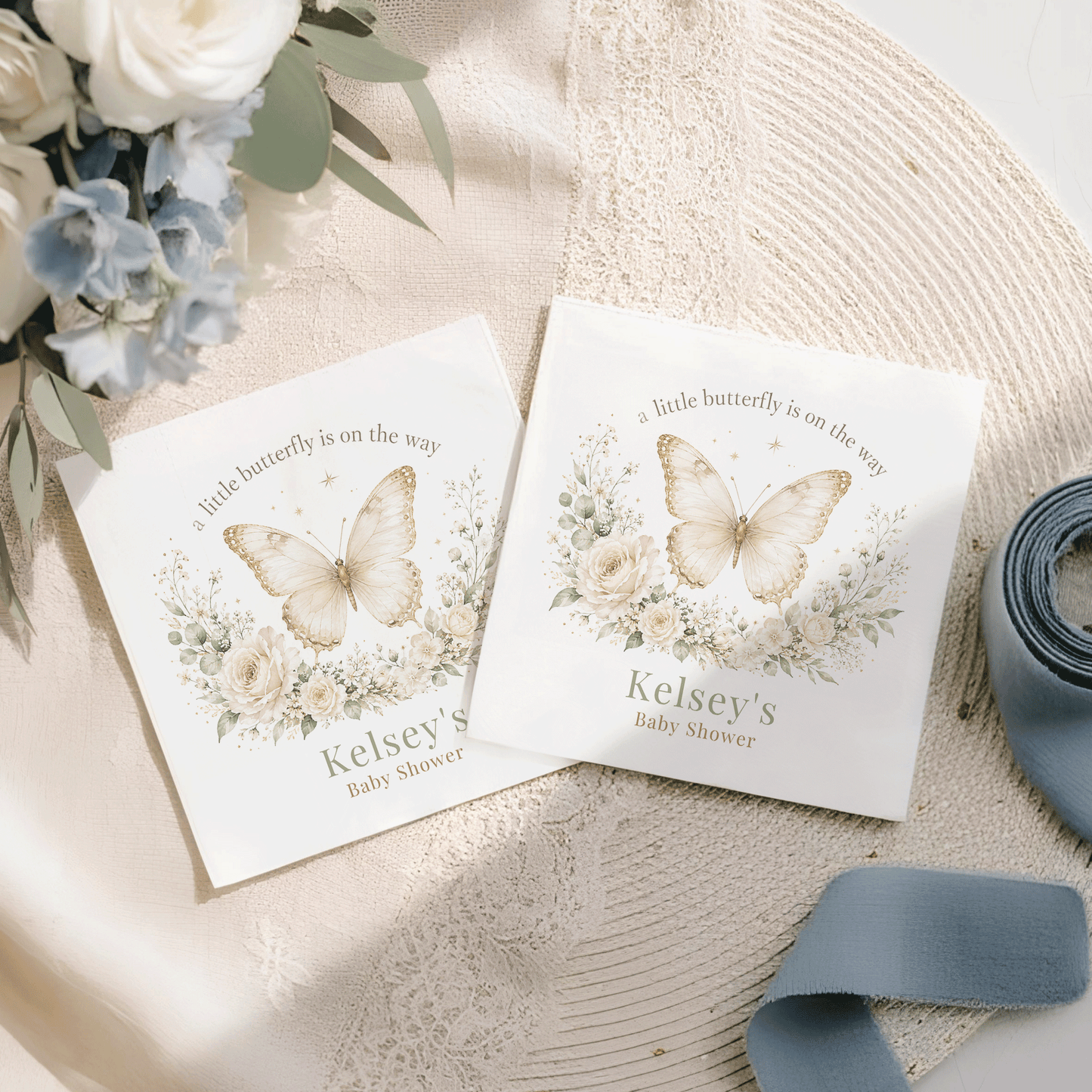 Two white baby shower cards with butterflies and flowers, reading "Kelsey's Baby Shower".