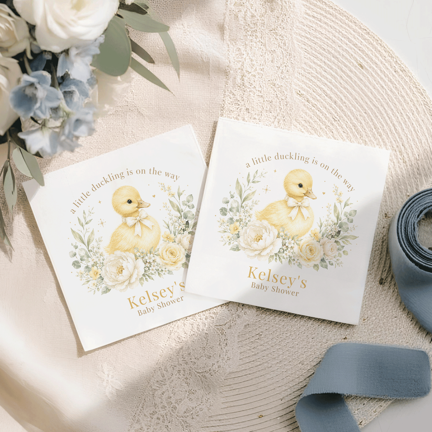 Two white cards with a duckling, flowers, and "Kelsey's Baby Shower" text.