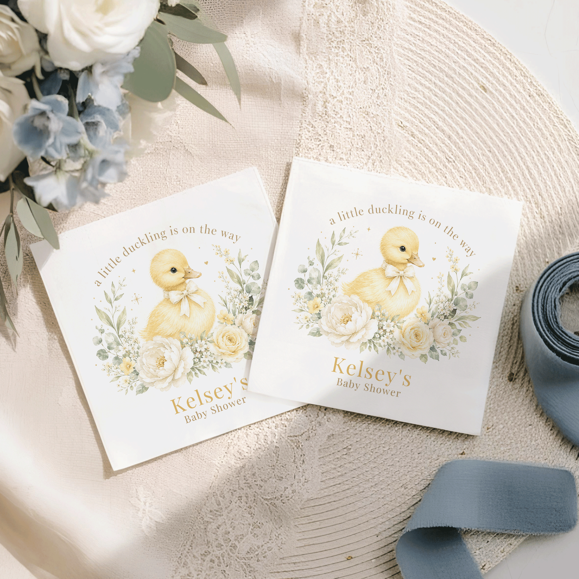Two white cards with a duckling, flowers, and "Kelsey's Baby Shower" text.