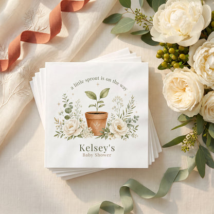Cream and sage baby shower napkin with a seedling in a terracotta pot, ivory peonies, eucalyptus and a personalized name in green