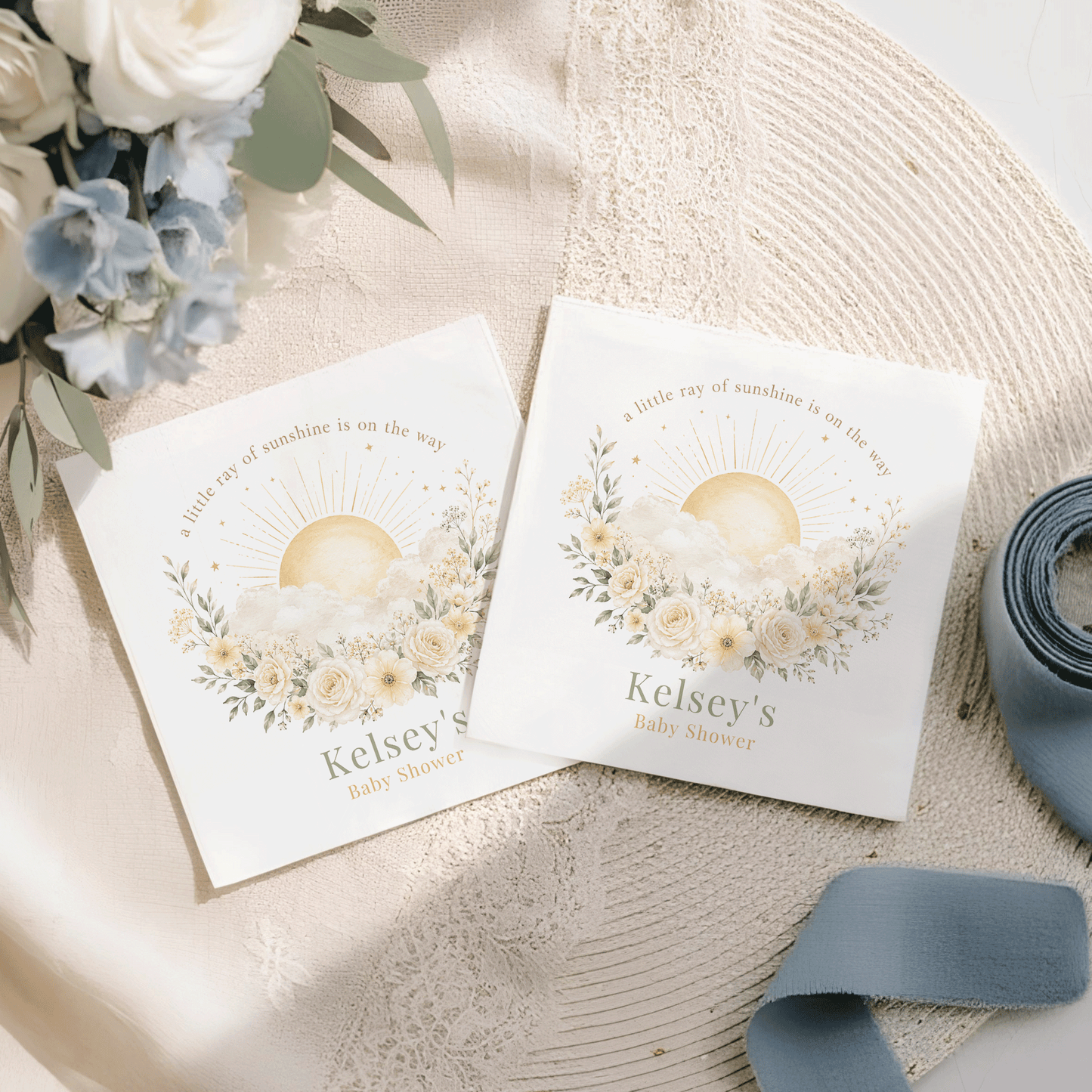 Two baby shower invitations with sun, clouds, and floral design for Kelsey's.