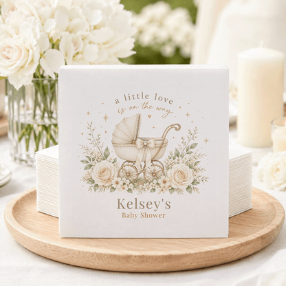Baby shower napkins with "Kelsey's Baby Shower" and vintage carriage design.