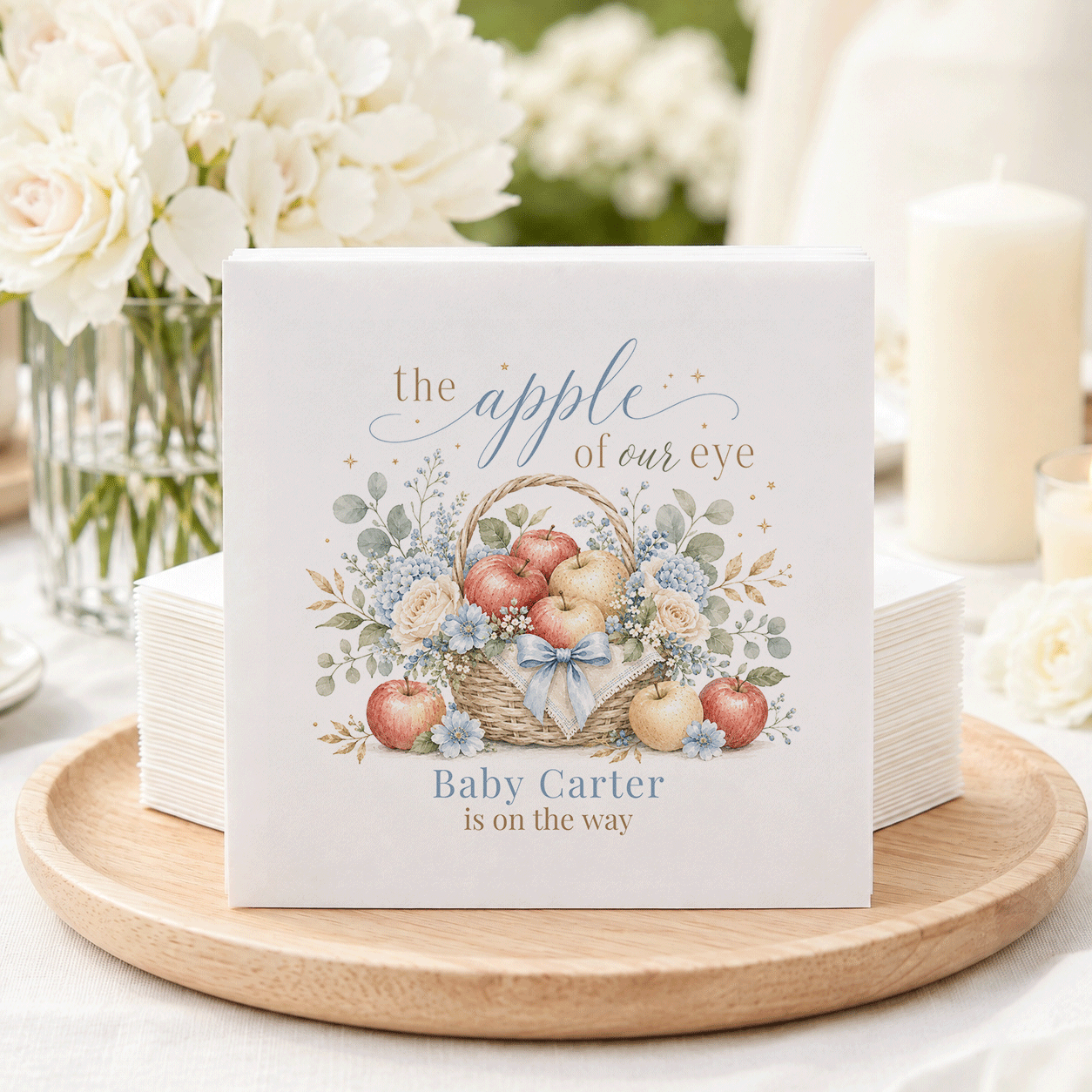 Napkins with "the apple of our eye" and "Baby Carter is on the way" text.