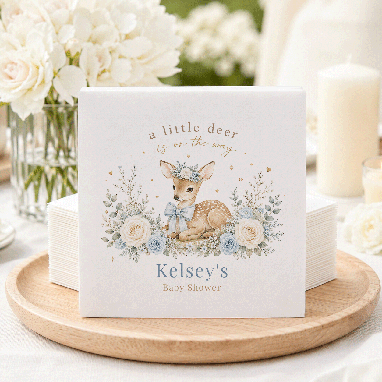 Baby shower napkins with a deer illustration and text "Kelsey's Baby Shower."