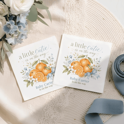 Two baby shower cards with "a little cutie is on the way" and orange illustrations.