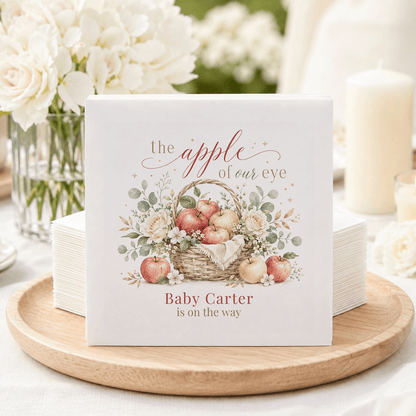 Napkins with a basket of apples illustration and text "Baby Carter is on the way."
