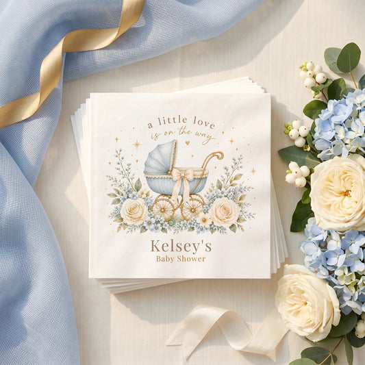 Dusty blue baby shower napkin with a vintage pram, ivory bow, forget me nots and a personalized name in warm brown