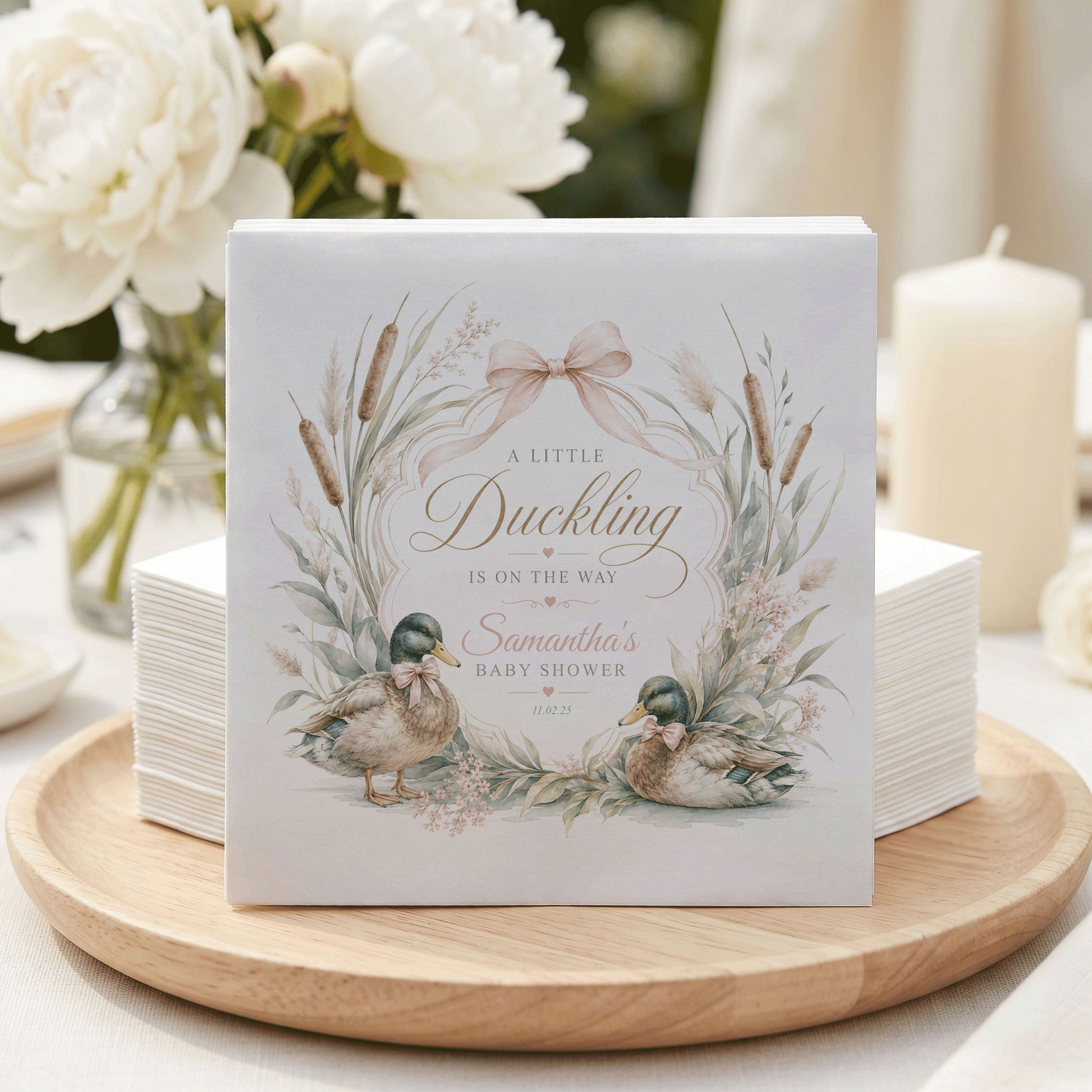 A Little Duckling baby shower invitation with two ducks and floral accents.