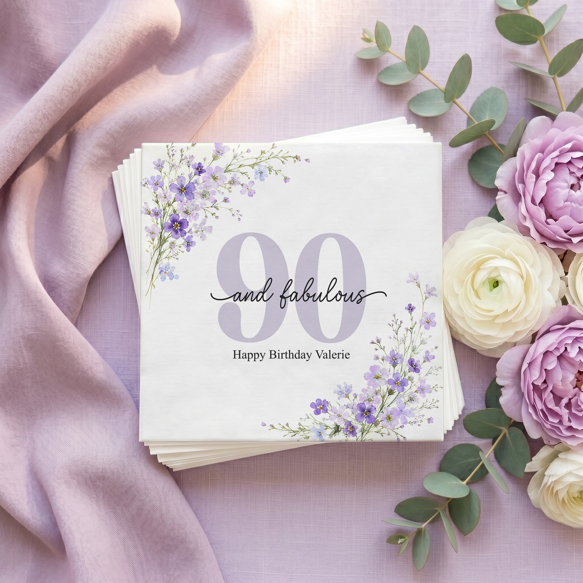 Napkins with "90 and fabulous Happy Birthday Valerie" and floral accents.