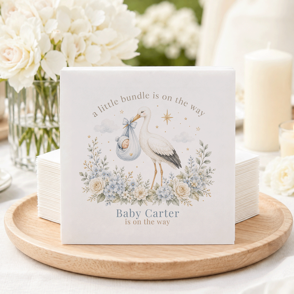 Baby Carter is on the way announcement with stork, baby, and flowers.