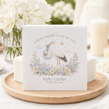 Baby Carter is on the way announcement with stork, baby, and flowers.