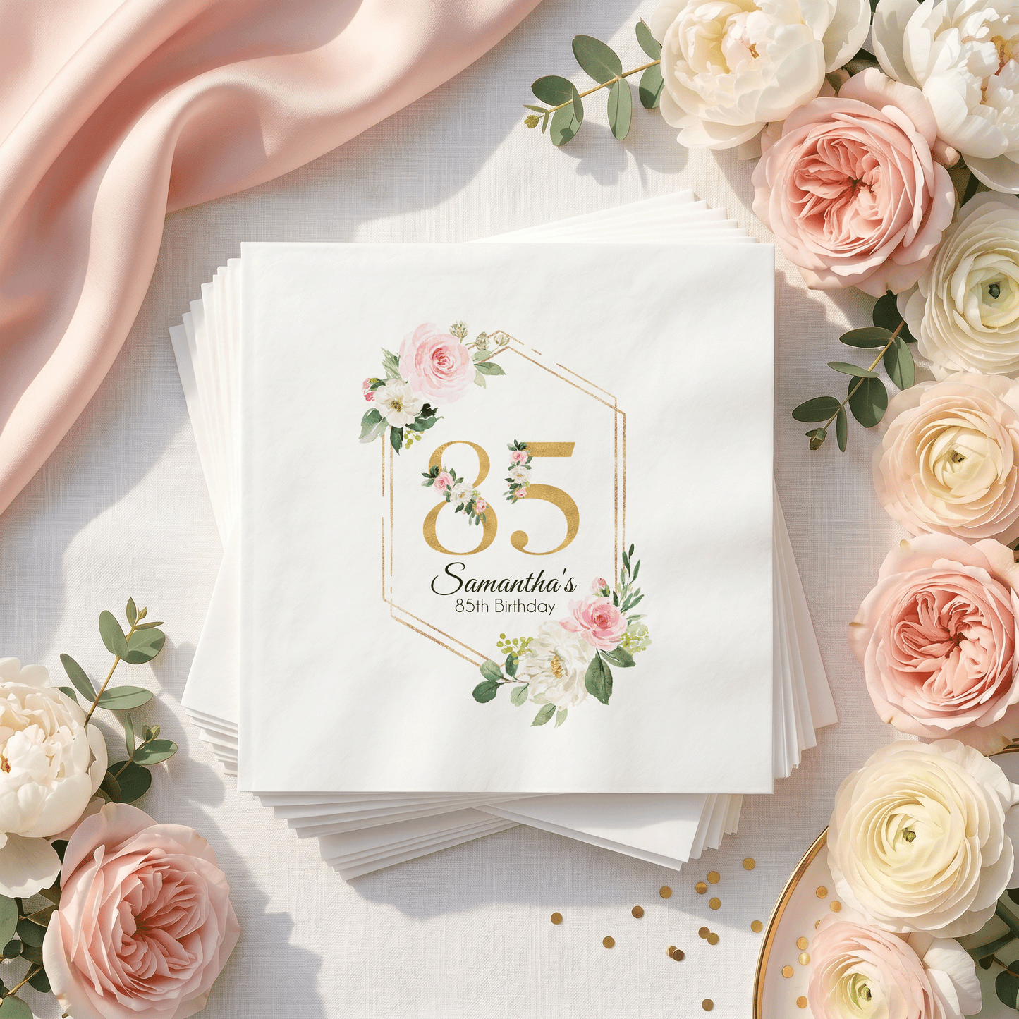 White napkins with floral "85th Birthday" design and "Samantha's" text.